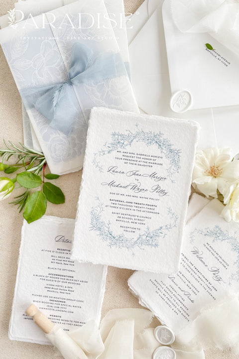 This exquisite wedding invitations suite offers a blend of coastal romance and bohemian charm. Perfect for a beach wedding, the invitations feature a delicate floral stationery design printed with crisp white ink on a translucent vellum jacket. The vellum wrap adds a touch of modern elegance and creates a beautifully layered look, perfectly complementing the carefree yet sophisticated vibe of this boho chic stationery.