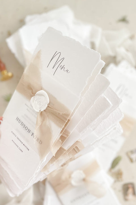 Add effortless sophistication to your tablescape with our handmade paper wedding menus, featuring deckled edges, soft watercolor washes, and wax seal accents. Each menu is printed on luxury cotton rag paper, combining fine art texture with natural tones for a look that’s both timeless and organic. Perfect for romantic, modern, or boho weddings, these menus elevate your reception décor while reflecting the artisanal charm of handcrafted stationery.