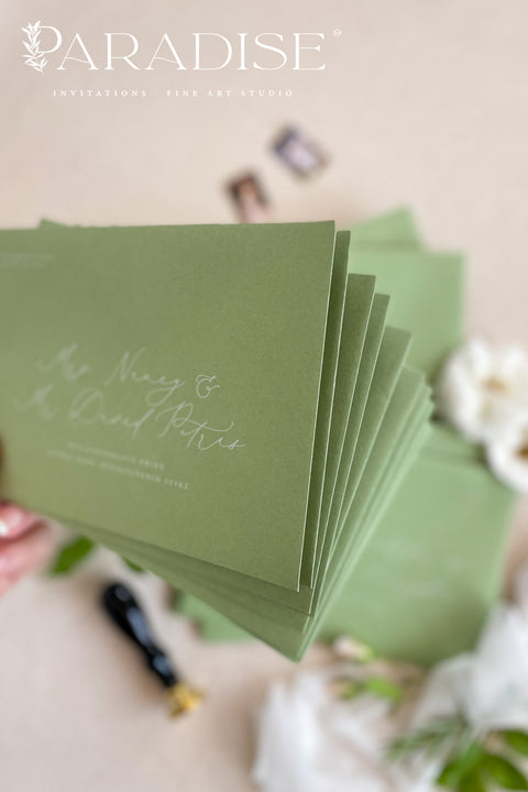 Close-up of pear green envelopes featuring elegant address printing on textured paper, highlighting refined typography and premium stationery quality.