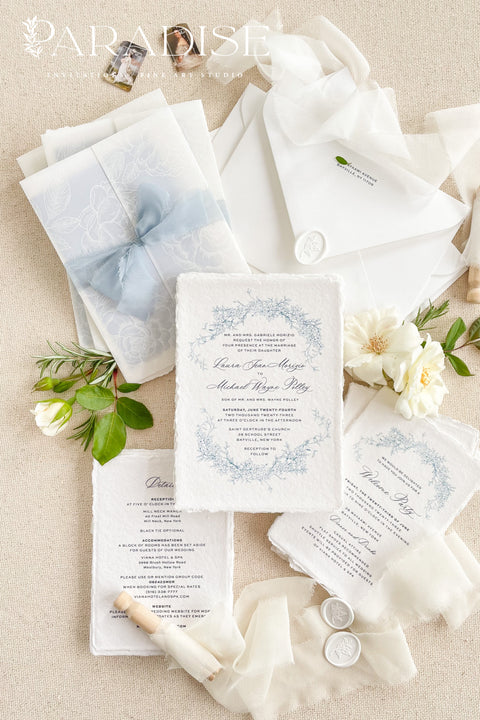 This exquisite wedding invitations suite offers a blend of coastal romance and bohemian charm. Perfect for a beach wedding, the invitations feature a delicate floral stationery design printed with crisp white ink on a translucent vellum jacket. The vellum wrap adds a touch of modern elegance and creates a beautifully layered look, perfectly complementing the carefree yet sophisticated vibe of this boho chic stationery.