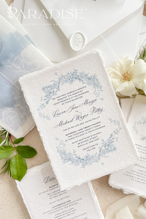 This exquisite wedding invitations suite offers a blend of coastal romance and bohemian charm. Perfect for a beach wedding, the invitations feature a delicate floral stationery design printed with crisp white ink on a translucent vellum jacket. The vellum wrap adds a touch of modern elegance and creates a beautifully layered look, perfectly complementing the carefree yet sophisticated vibe of this boho chic stationery.