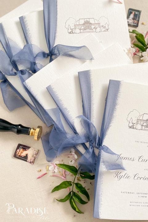Hand-drawn venue artwork meets fine-art craftsmanship in these beautifully assembled wedding programs. The soft blue ribbon, textured cotton paper, and delicate illustration create an heirloom-quality piece that sets the tone for a romantic, detail-rich ceremony. Each program balances sophistication with warmth, offering guests a meaningful preview of your celebration.