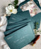 Emerald green wedding envelopes with floral envelope liners, crafted from premium paper and featuring fine art botanical illustrations inside.
