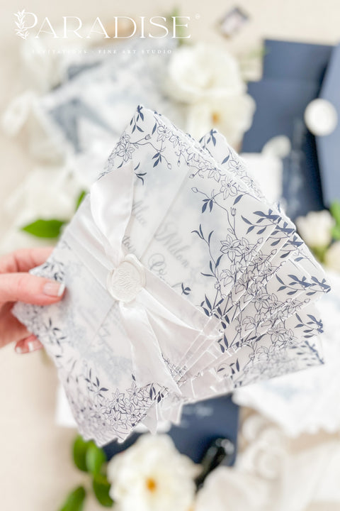 Celebrate your love with elegance and craftsmanship through our handmade blue fine art wedding invitations, featuring deckled-edge cotton paper, soft botanical designs, and luxurious vellum wraps tied with delicate silk ribbon and a custom wax seal. This suite combines timeless artistry with modern sophistication, perfect for coastal, fine art, or destination weddings seeking a romantic and refined aesthetic.