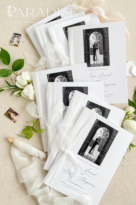 A beautifully printed ceremony program featuring your favorite photograph, wrapped in soft chiffon ribbon and crafted on luxurious fine-art paper. The design blends modern minimalism with heartfelt storytelling - allowing your guests to step into your love story the moment they take their seat. With its elegant typography, timeless black-and-white imagery, and heirloom-quality materials, it becomes more than a program - it becomes a cherished keepsake of your day.