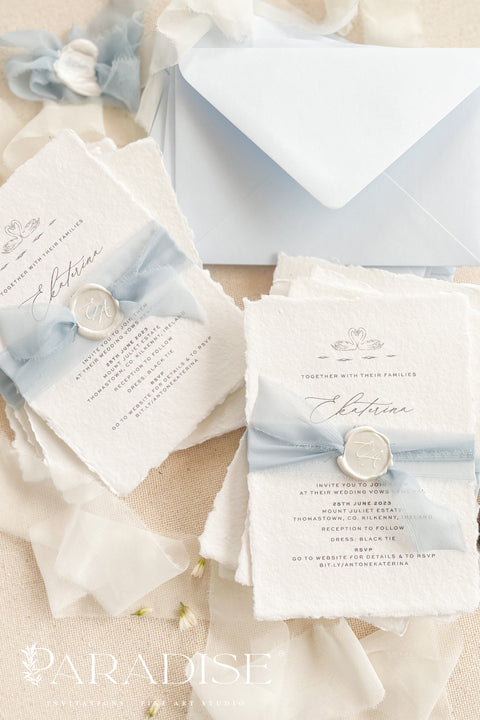 Delicate, timeless, and effortlessly romantic - this handmade paper wedding invitation suite is the perfect blend of fine art elegance and heartfelt simplicity. Printed on luxury deckled-edge cotton paper, each invitation exudes artisanal charm, its softly torn edges and tactile texture embodying the beauty of handcrafted design. Tied with a dusty blue silk ribbon and sealed with a white wax monogram, this suite radiates an ethereal calm - a whisper of something classic and pure. 