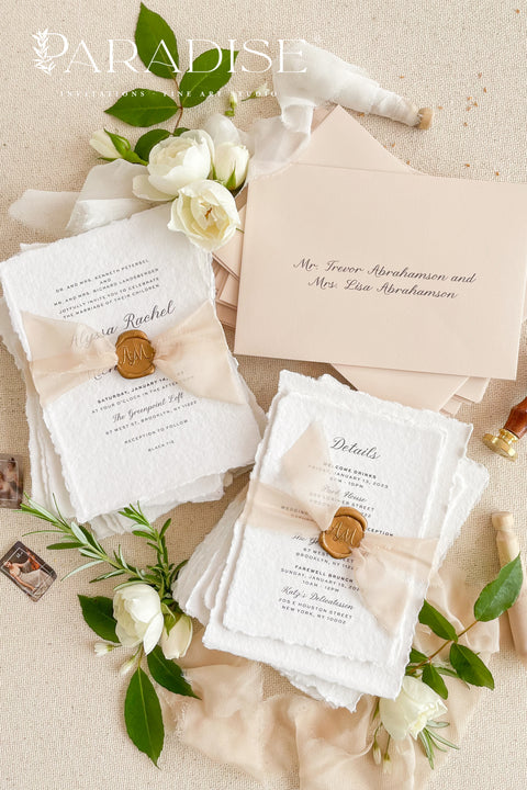 Announce your love story with timeless elegance through our&nbsp;handmade deckled-edge wedding invitations, beautifully detailed with soft blush tones, sheer ribbon, and custom wax seals. Each invitation is carefully crafted by hand using premium cotton paper for a naturally textured, fine art finish that embodies romance and sophistication.
