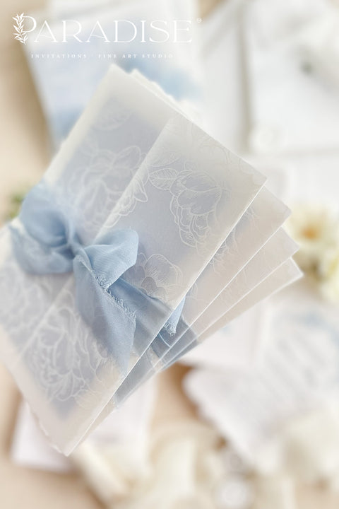 This exquisite wedding invitations suite offers a blend of coastal romance and bohemian charm. Perfect for a beach wedding, the invitations feature a delicate floral stationery design printed with crisp white ink on a translucent vellum jacket. The vellum wrap adds a touch of modern elegance and creates a beautifully layered look, perfectly complementing the carefree yet sophisticated vibe of this boho chic stationery.