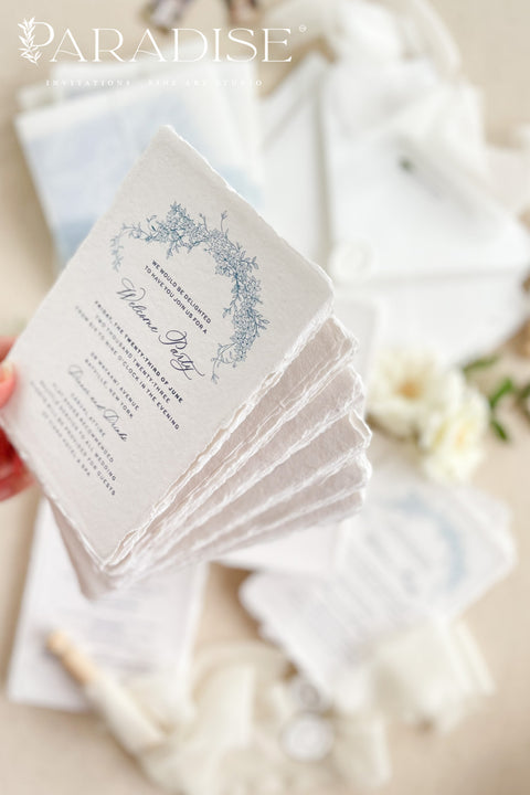 This exquisite wedding invitations suite offers a blend of coastal romance and bohemian charm. Perfect for a beach wedding, the invitations feature a delicate floral stationery design printed with crisp white ink on a translucent vellum jacket. The vellum wrap adds a touch of modern elegance and creates a beautifully layered look, perfectly complementing the carefree yet sophisticated vibe of this boho chic stationery.