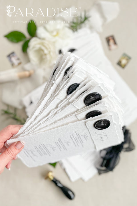 Add a touch of timeless sophistication to your wedding table with our handmade paper menus, sealed with a luxurious black wax emblem. Crafted on deckled-edge cotton rag paper, these menus embody fine art elegance and artisanal craftsmanship - a perfect balance of simplicity and grandeur. Ideal for romantic, modern, or classic weddings, each menu is hand-finished for a refined aesthetic that leaves a lasting impression on your guests.