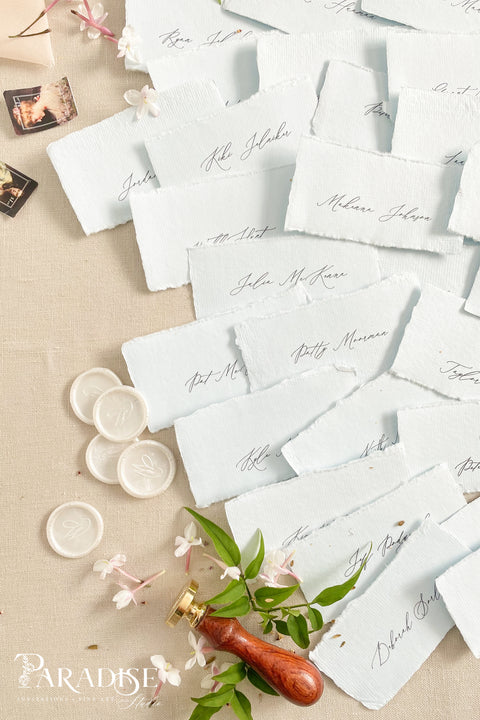Add soft color and fine-art elegance to your event with our colored handmade paper place cards, crafted from luxurious cotton rag paper and finished with naturally torn deckled edges. Each card features refined calligraphy and a subtle organic texture, creating a beautifully romantic detail perfect for weddings, showers, rehearsal dinners, or elevated celebrations. Their artisanal feel and pastel tones bring charm, sophistication, and warmth to any tablescape.