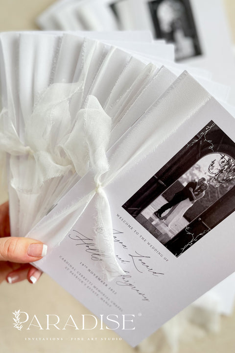 A beautifully printed ceremony program featuring your favorite photograph, wrapped in soft chiffon ribbon and crafted on luxurious fine-art paper. The design blends modern minimalism with heartfelt storytelling - allowing your guests to step into your love story the moment they take their seat. With its elegant typography, timeless black-and-white imagery, and heirloom-quality materials, it becomes more than a program - it becomes a cherished keepsake of your day.