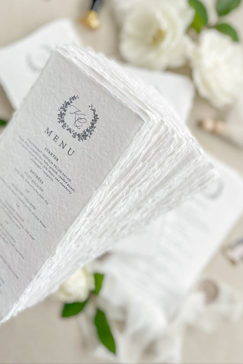Add timeless romance to your table with our handmade paper wedding menus, tied with soft silk bows for an ethereal fine-art look. Crafted from cotton rag paper with delicate deckled edges, each menu exudes understated luxury - perfect for elegant garden, estate, or romantic indoor weddings. Designed to complement any refined tablescape, these menus blend artisanal craftsmanship with modern calligraphy and soft neutral tones for an effortlessly graceful presentation.