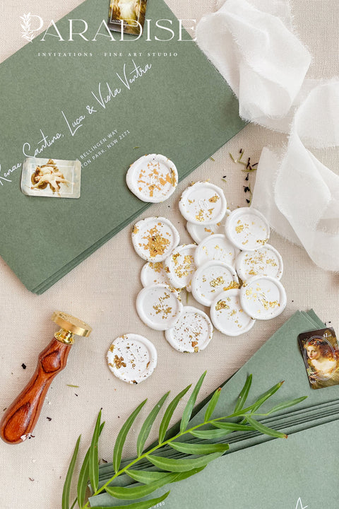 Add a refined finishing touch to your stationery with these handcrafted ivory wax seals, delicately scattered with gold leaf for a soft yet luxurious effect. Each seal is individually poured and stamped, creating organic edges and subtle variations that highlight the beauty of true artisan work. Perfect for wedding invitations, envelopes, menus, or favors, these wax seals bring timeless elegance and a curated, fine-art feel to every detail.