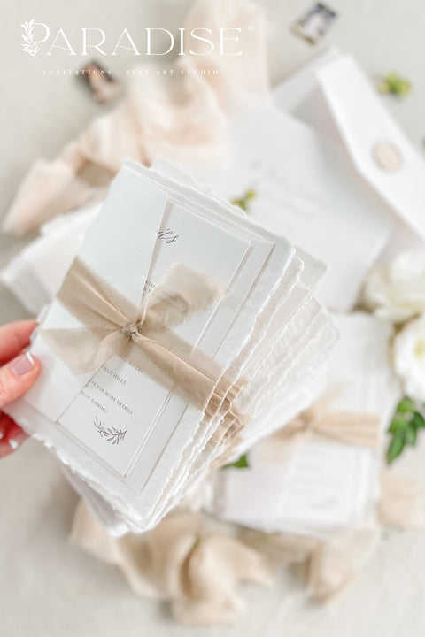 Refined, personal, and beautifully timeless - our handmade wedding invitation suite with a hand-drawn venue illustration transforms your wedding stationery into a piece of art. Each invitation is printed on 100% cotton deckled-edge paper, tied with a soft taupe silk ribbon, and sealed with an ivory wax seal for a sophisticated, heirloom finish. The custom venue sketch captures the heart of your celebration. 