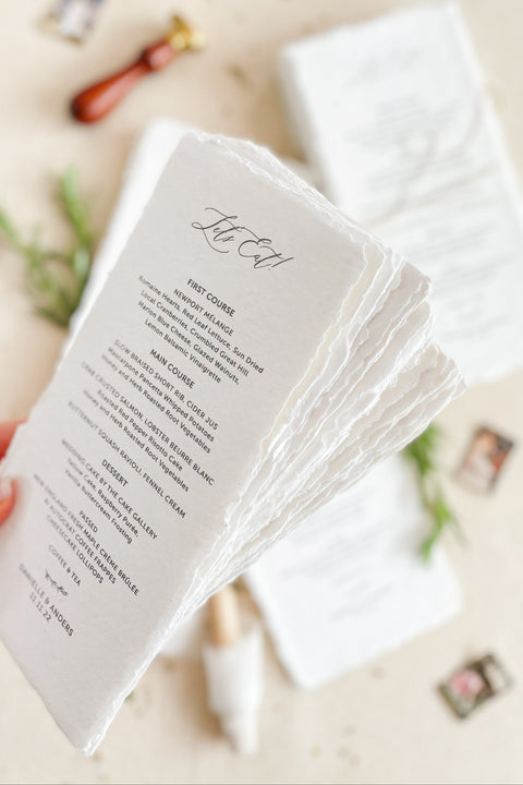 Bring artisanal beauty to your tablescape with our handmade paper wedding menus, crafted from 100% cotton rag paper and finished with elegant deckled edges. Each menu is a tactile piece of fine-art stationery, designed for couples who love timeless details and refined simplicity. Perfect for luxury, romantic, or destination weddings, these menus feature minimalist typography printed on naturally textured paper, adding warmth and sophistication to your reception.
