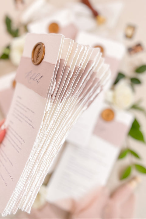 Add a romantic and refined touch to your reception with our handmade paper wedding menus, featuring dusty rose accents and gold wax seals. Each piece is crafted on luxury cotton paper with soft deckled edges, blending timeless charm with contemporary elegance - perfect for fine art or garden-inspired weddings. These menus effortlessly elevate your table styling, creating a cohesive and sophisticated dining experience.