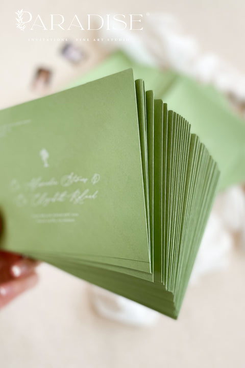Close-up of pear green envelopes featuring elegant address printing on textured paper, highlighting refined typography and premium stationery quality.