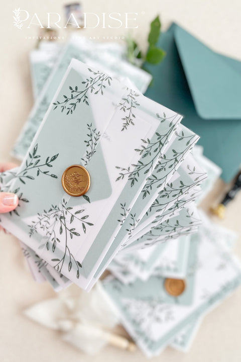 Romantic, refined, and inspired by nature - our botanical vellum wedding invitations are crafted for couples who love timeless design with an organic touch. Each invitation features delicate greenery illustrations, wrapped in a translucent vellum sleeve and sealed with a gold wax seal for an elegant, fine art finish. The deep emerald and sage green envelopes perfectly complement the natural botanical design.