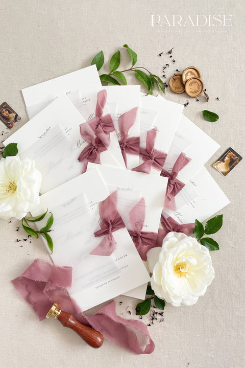 This wedding invitation suite exudes timeless romance and refined modernity, perfect for couples who love soft luxury and intentional design. Wrapped in delicate vellum jackets and tied with rich burgundy silk ribbons, each invitation feels like an elegant love letter - graceful, textured, and unforgettable. Printed on luxury fine art cardstock, the minimalist typography and spacious layout create a beautifully balanced aesthetic that feels both modern and classic.
