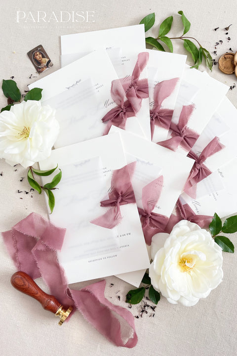 This wedding invitation suite exudes timeless romance and refined modernity, perfect for couples who love soft luxury and intentional design. Wrapped in delicate vellum jackets and tied with rich burgundy silk ribbons, each invitation feels like an elegant love letter - graceful, textured, and unforgettable. Printed on luxury fine art cardstock, the minimalist typography and spacious layout create a beautifully balanced aesthetic that feels both modern and classic.