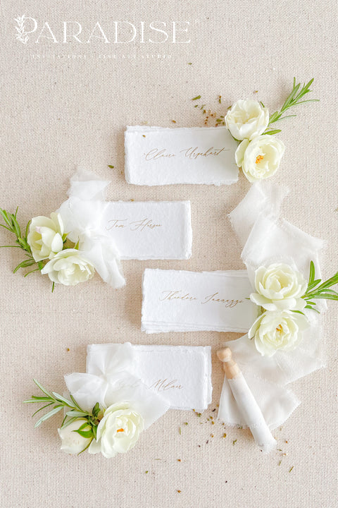 Create a romantic, fine-art tablescape with our handmade paper place cards, crafted from luxurious cotton rag paper and finished with soft, torn deckled edges. Each card features elegant calligraphy, delicate chiffon ribbon, and a timeless organic texture - perfect for weddings, intimate dinners, bridal showers, or upscale celebrations. These artisan-crafted pieces bring softness, refinement, and natural beauty to any seating display.