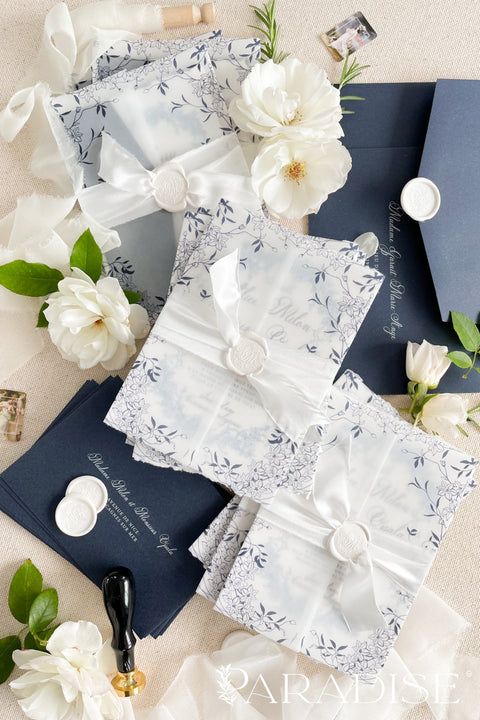 Celebrate your love with elegance and craftsmanship through our handmade blue fine art wedding invitations, featuring deckled-edge cotton paper, soft botanical designs, and luxurious vellum wraps tied with delicate silk ribbon and a custom wax seal. This suite combines timeless artistry with modern sophistication, perfect for coastal, fine art, or destination weddings seeking a romantic and refined aesthetic.