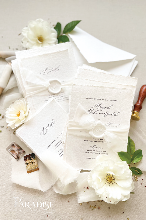 Elegant, refined, and crafted by hand - our handmade wedding invitation suite captures the essence of modern romance. Printed on 100% cotton deckled-edge paper, each invitation is delicately tied with an ivory chiffon ribbon and sealed with a white wax monogram, creating an heirloom piece that feels soft, timeless, and beautifully personal.