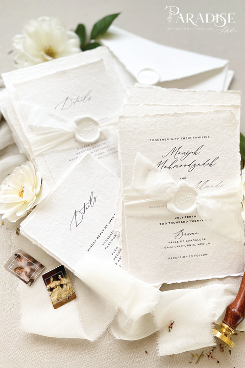 Elegant, refined, and crafted by hand - our handmade wedding invitation suite captures the essence of modern romance. Printed on 100% cotton deckled-edge paper, each invitation is delicately tied with an ivory chiffon ribbon and sealed with a white wax monogram, creating an heirloom piece that feels soft, timeless, and beautifully personal.