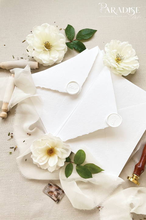 Elegant, refined, and crafted by hand - our handmade wedding invitation suite captures the essence of modern romance. Printed on 100% cotton deckled-edge paper, each invitation is delicately tied with an ivory chiffon ribbon and sealed with a white wax monogram, creating an heirloom piece that feels soft, timeless, and beautifully personal.