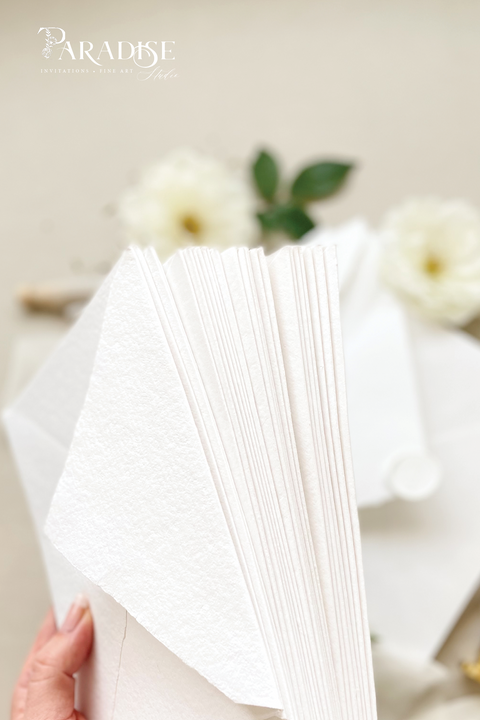 Elegant, refined, and crafted by hand - our handmade wedding invitation suite captures the essence of modern romance. Printed on 100% cotton deckled-edge paper, each invitation is delicately tied with an ivory chiffon ribbon and sealed with a white wax monogram, creating an heirloom piece that feels soft, timeless, and beautifully personal.