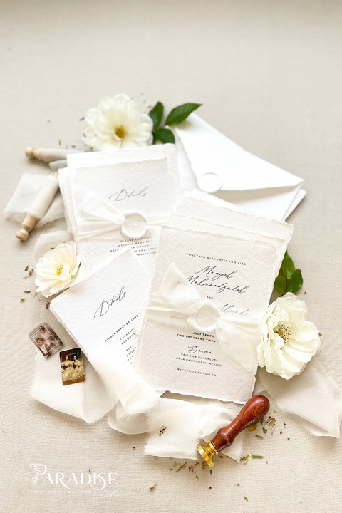 Elegant, refined, and crafted by hand - our handmade wedding invitation suite captures the essence of modern romance. Printed on 100% cotton deckled-edge paper, each invitation is delicately tied with an ivory chiffon ribbon and sealed with a white wax monogram, creating an heirloom piece that feels soft, timeless, and beautifully personal.